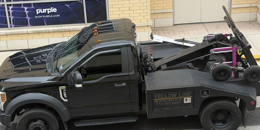 Yellow Line Towing's exact black Ford F-450 with side-box company branding